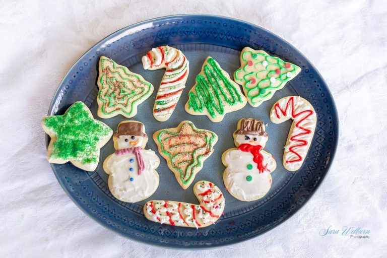 Christmas sugar cookies on a blue plate.