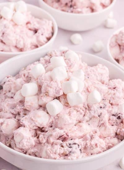 A bowl of pink cranberry dip with marshmallows.