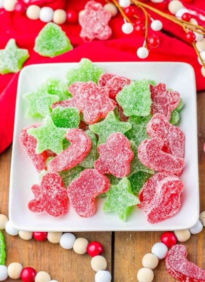 Christmas gummy candies on a white plate.