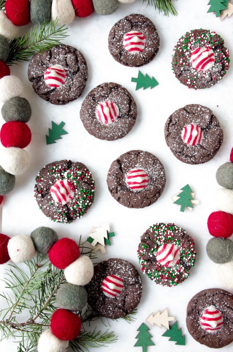 Chocolate peppermint cookies surrounded by christmas decorations.