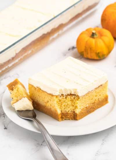 A slice of pumpkin cheesecake on a plate.
