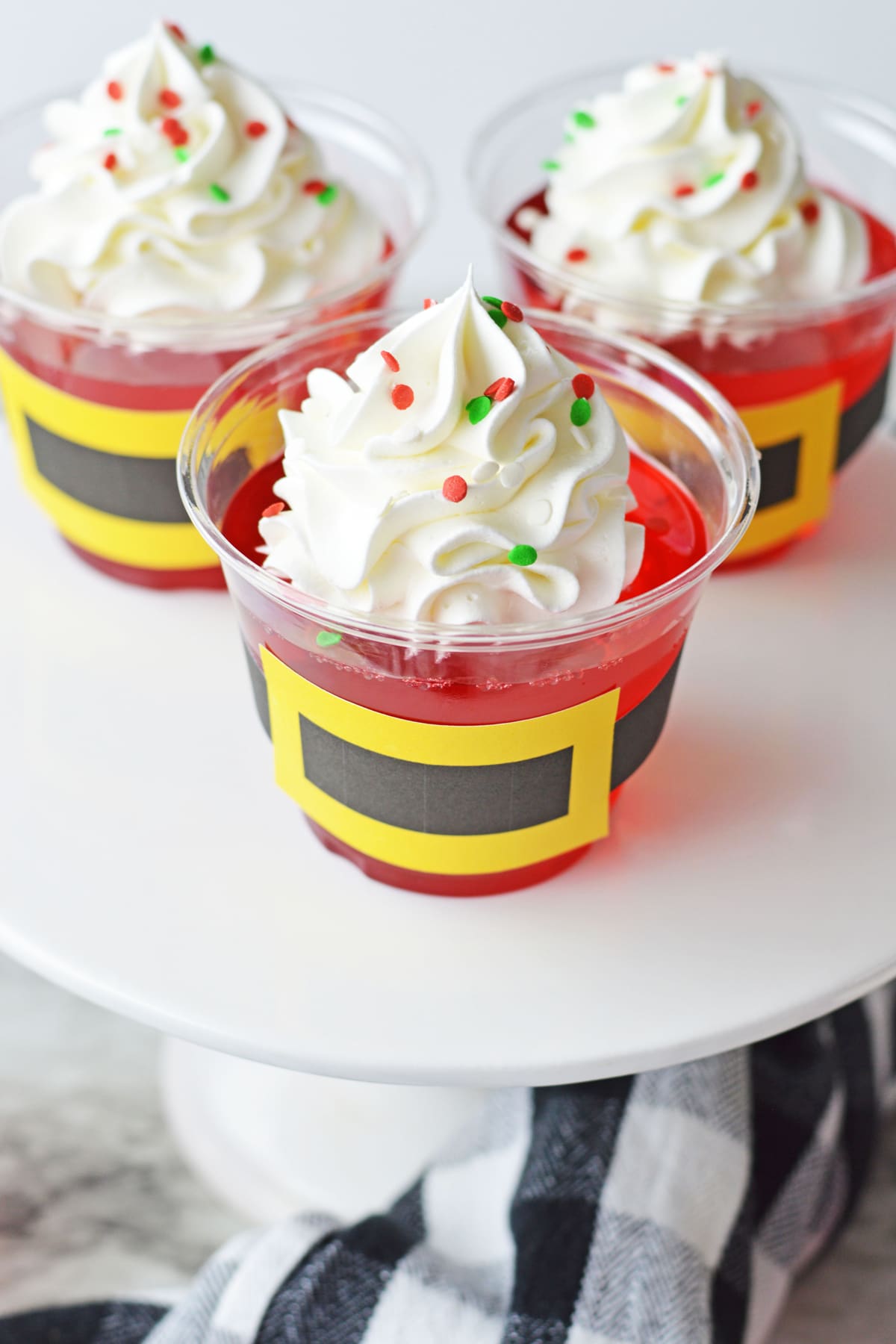 Santa claus jello cups with whipped cream and santa hats.