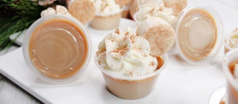Small cups with whipped cream and icing on them.