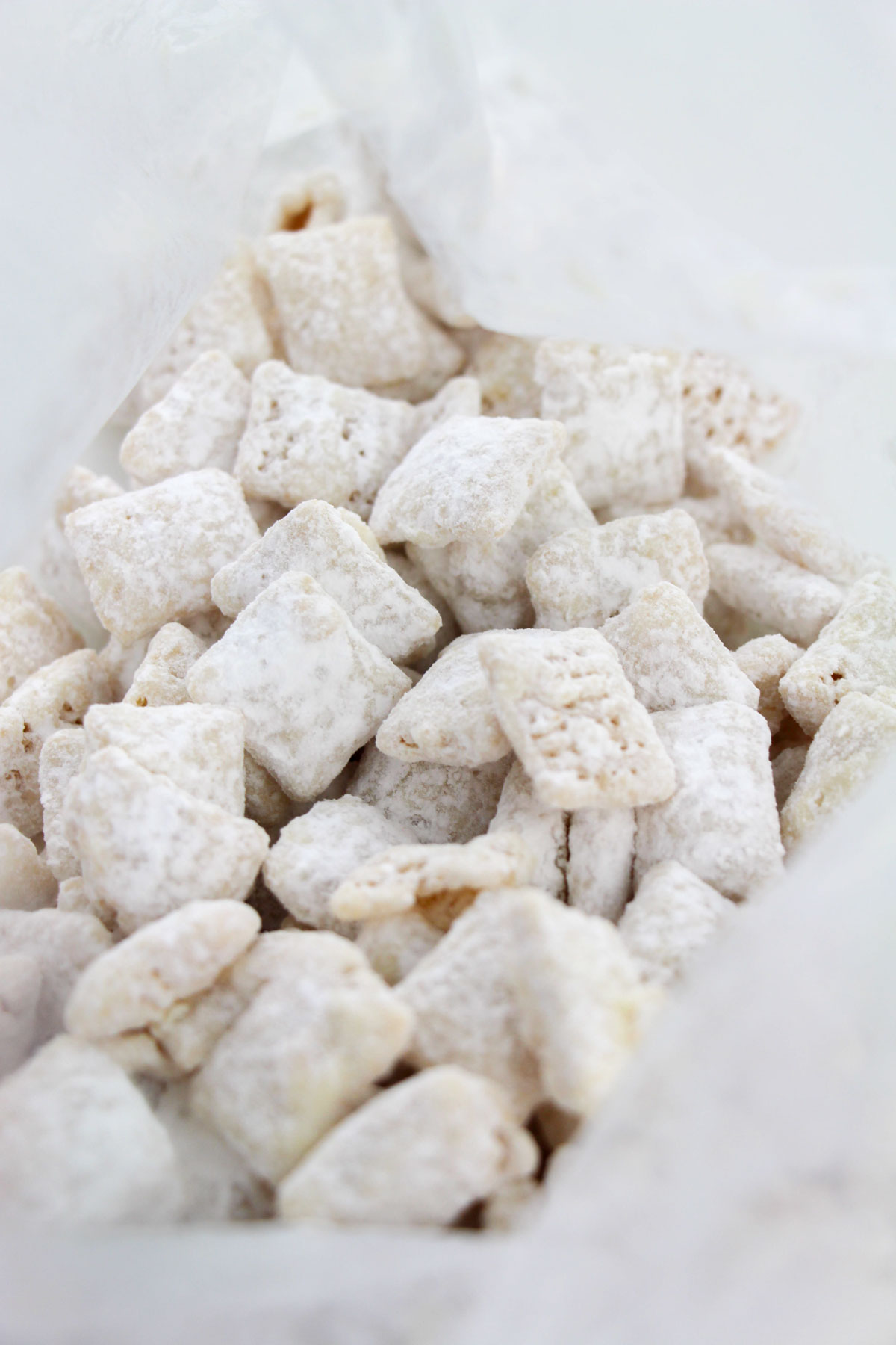 A bag of white powdered chex mix on a white surface.