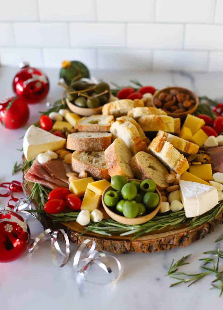 A platter with a variety of cheeses and meats on it.