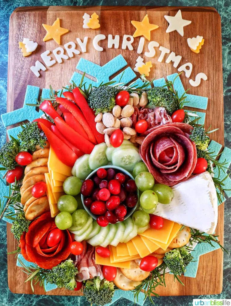 A merry christmas cheese wreath on a cutting board.