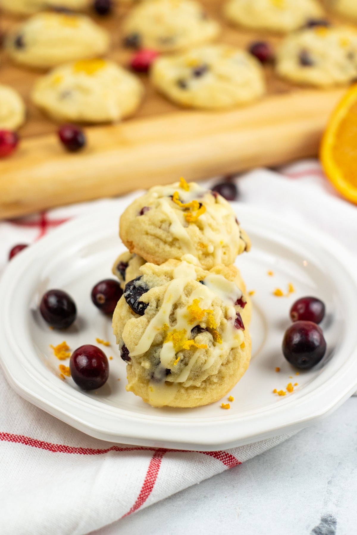 Orange cranberry cookies on a plate.