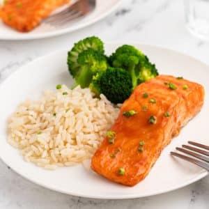 Honey Glazed Salmon on a plate with rice and broccoli.