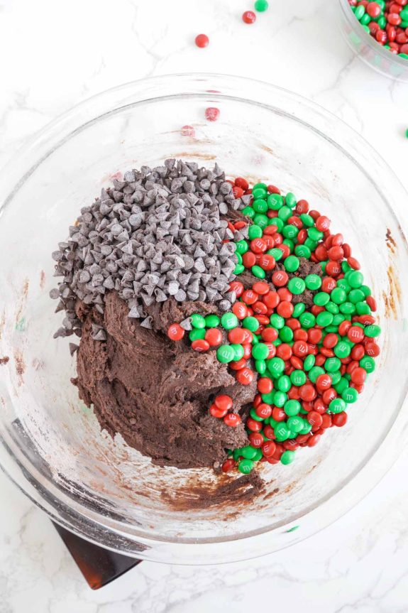 A bowl of chocolate brownie mix with green and red sprinkles.