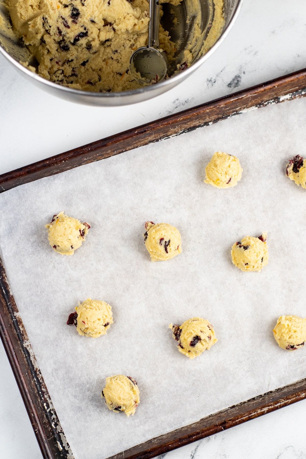 A baking sheet with Cranberry Orange Cookies on it.