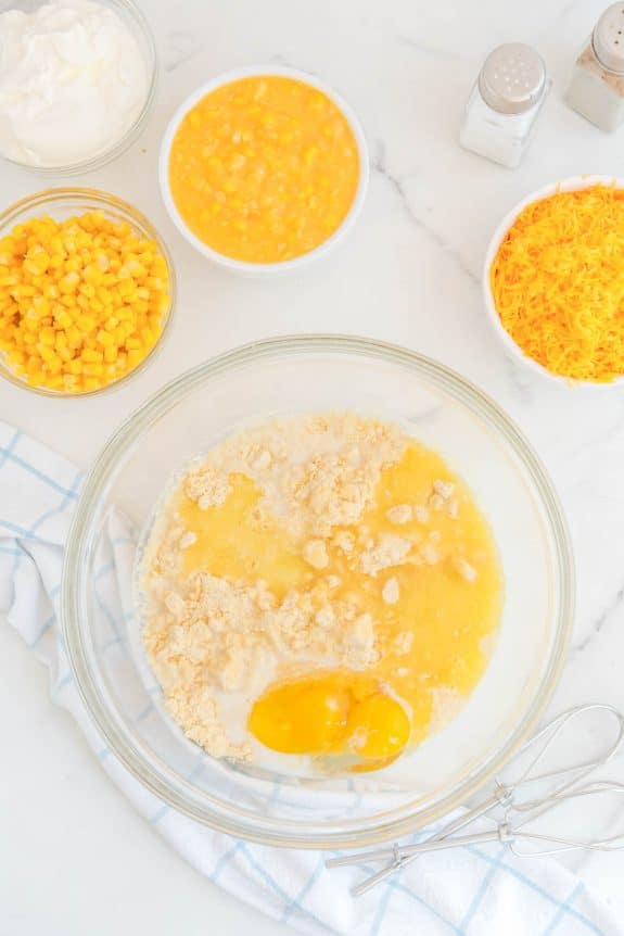 A bowl of cornmeal, eggs and other ingredients.