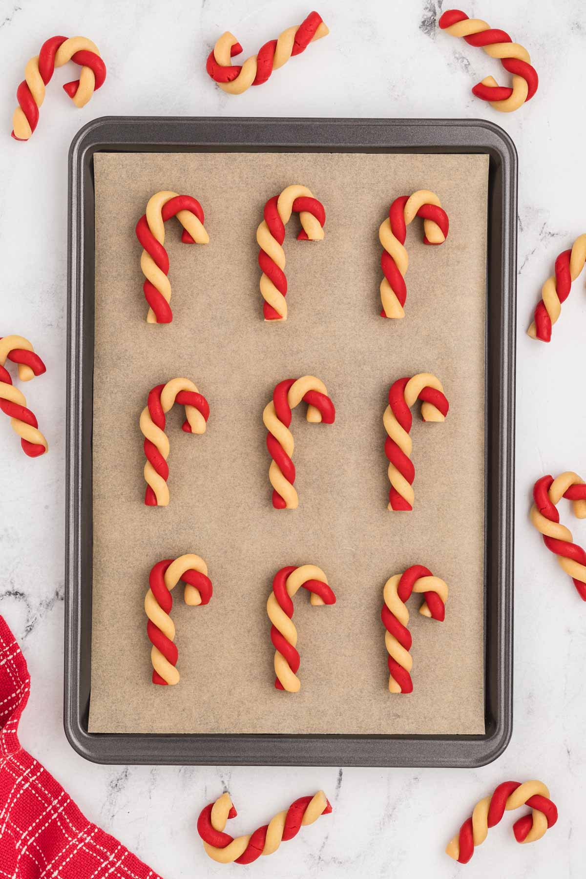 Candy cane cookies on a baking sheet.