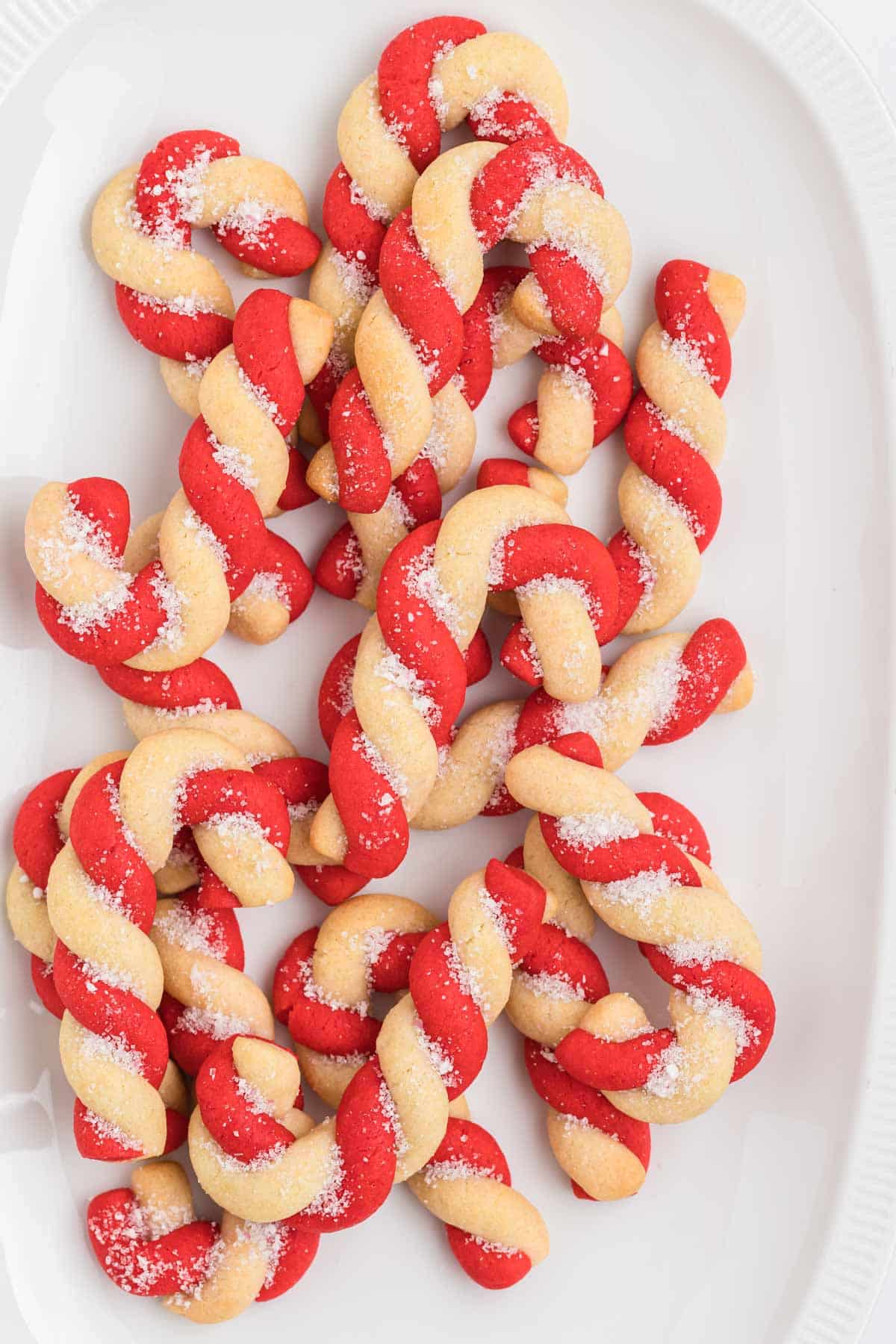 Candy cane cookies on a white plate.