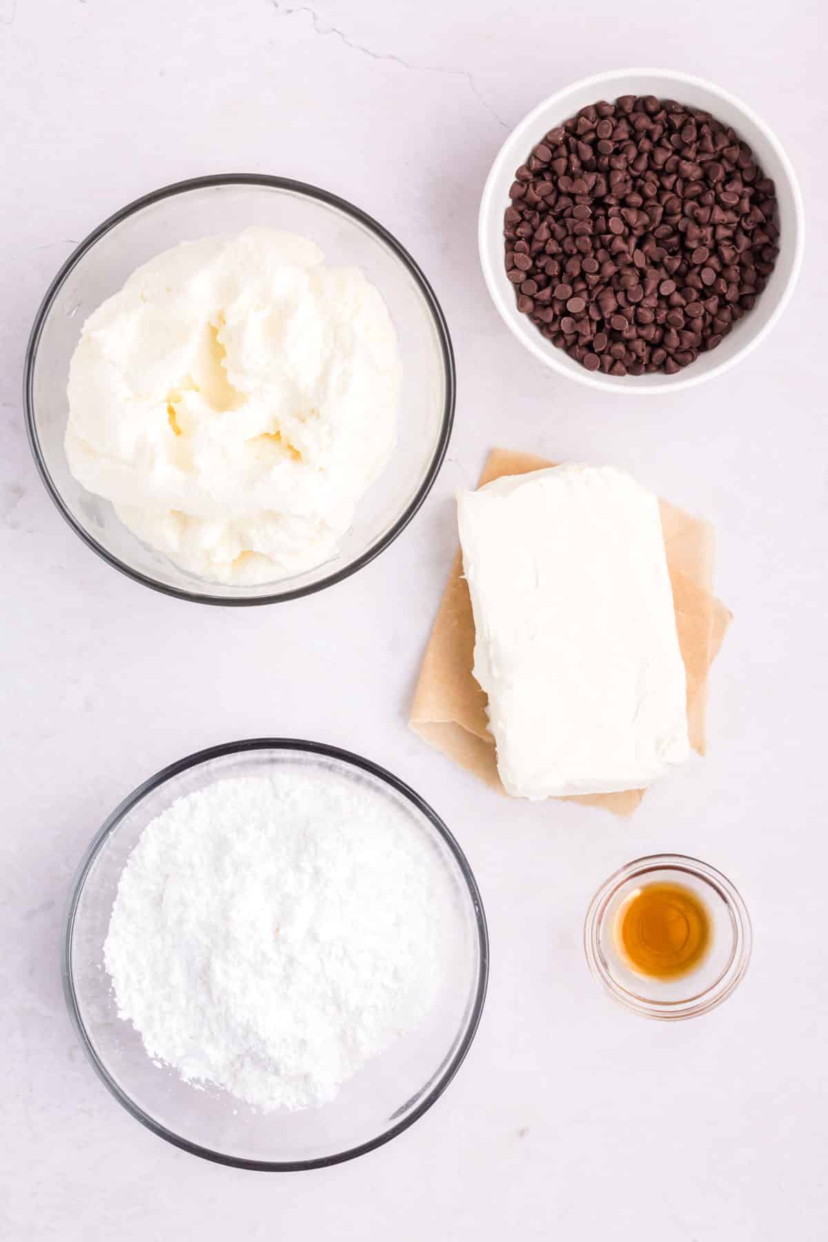 Cannoli dip ingredients are the following: powdered sugar, cream cheese, whole milk ricotta cheese, vanilla extract, and mini chocolate chips.