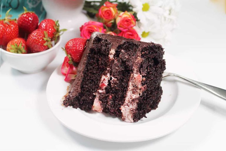 A slice of chocolate cake with strawberries on a plate.