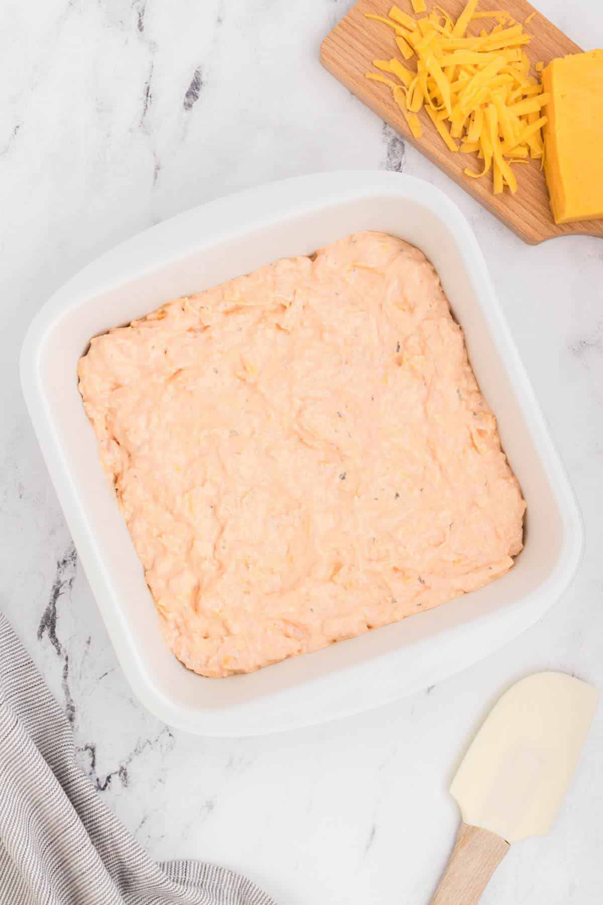 Cheesy cheesy dip in a white baking dish.
