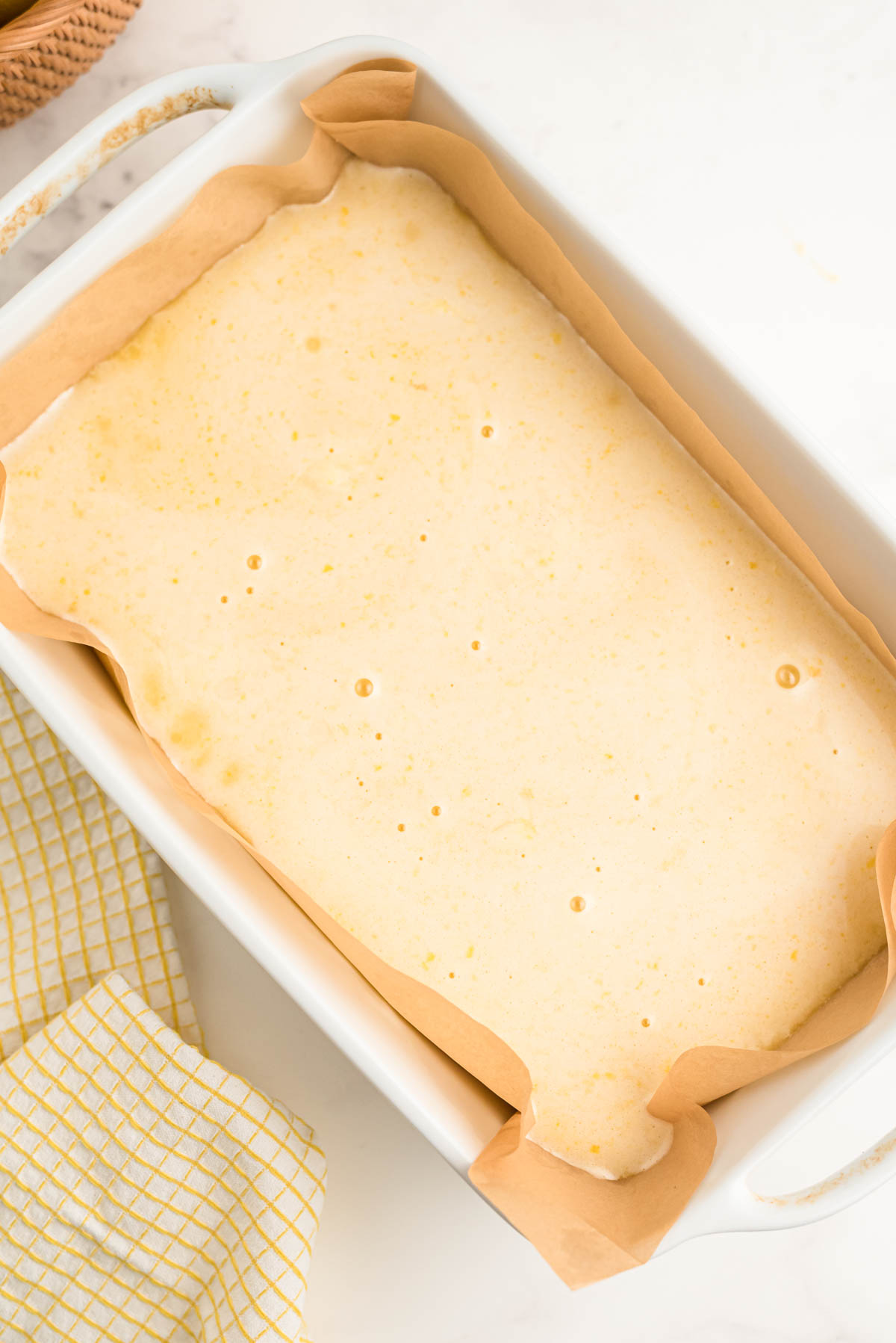 A baking dish with with unbaked lemon bars in it