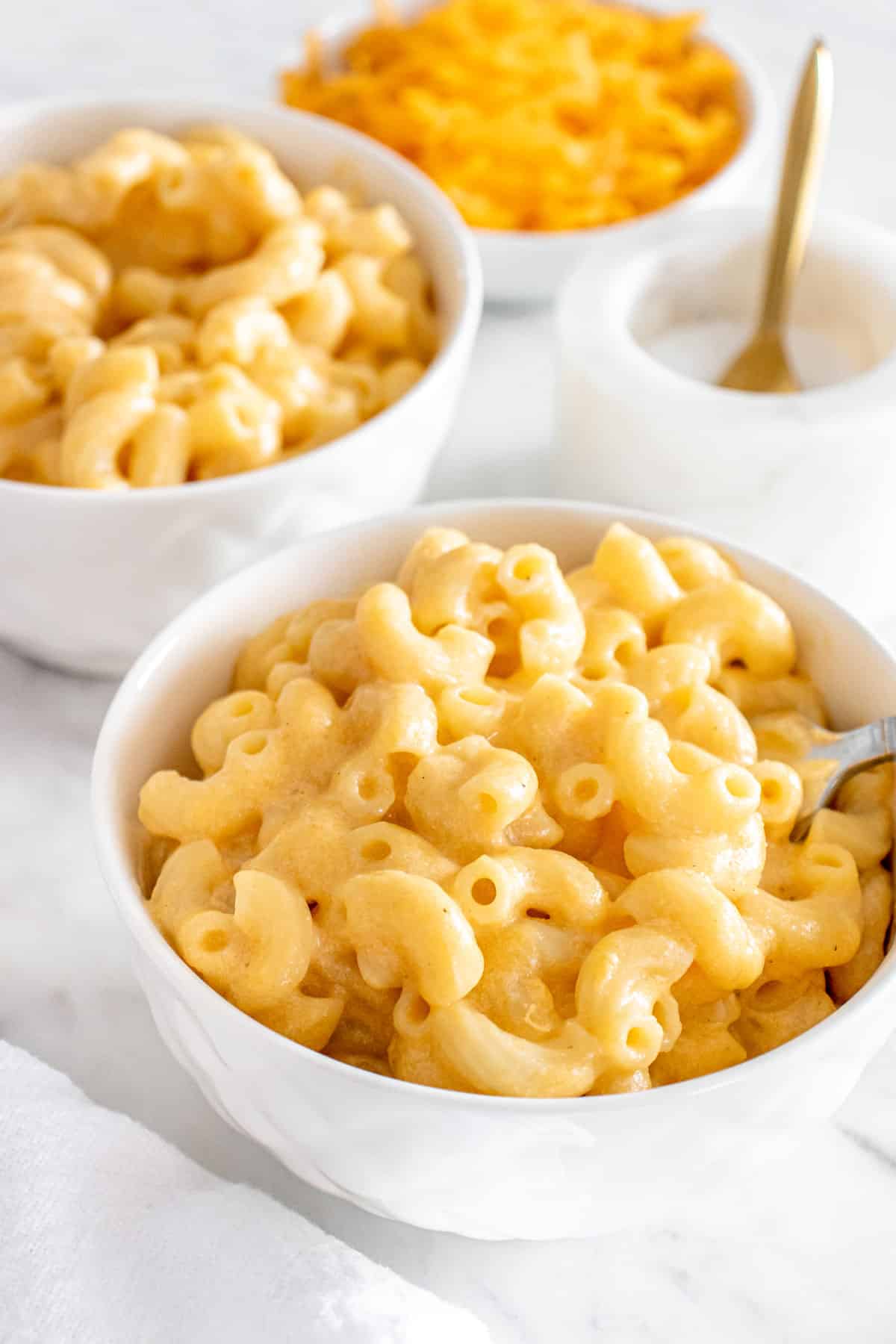 A bowl of Stovetop Mac and Cheese with ingredients on the side.