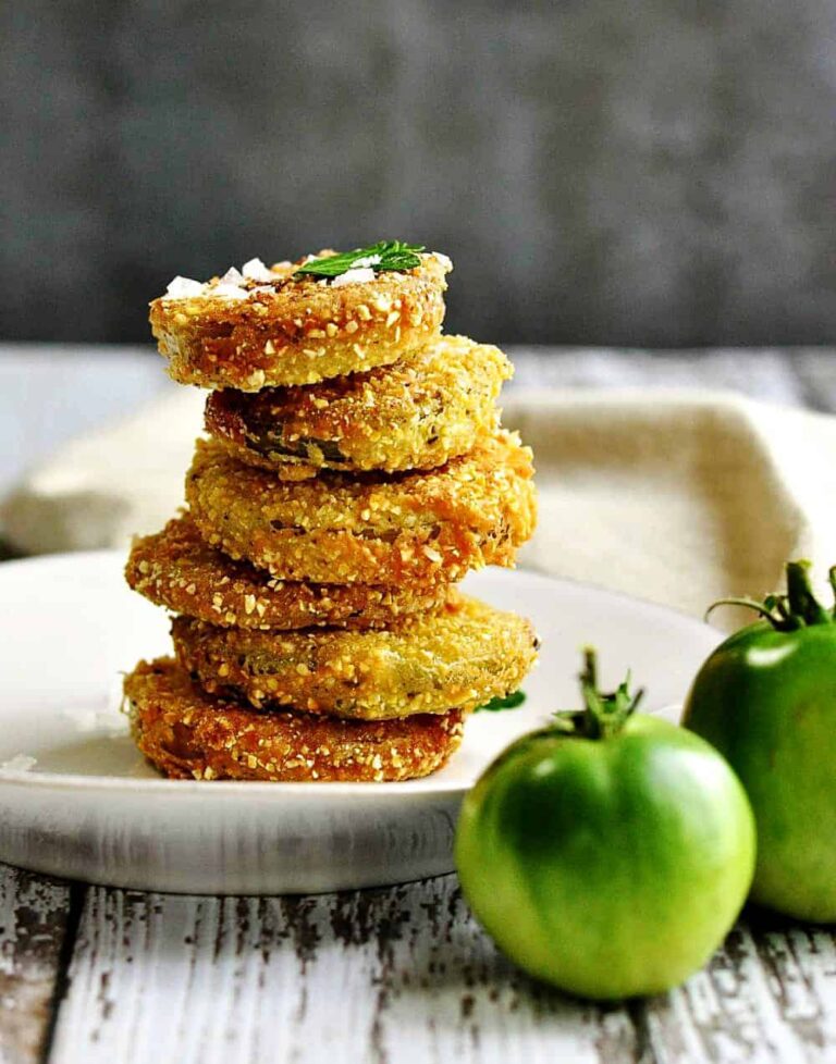 A stack of fried green tomatoes on a plate.