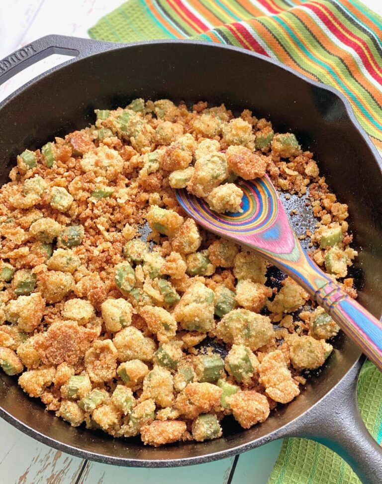Fried okra in a skillet with a spoon.