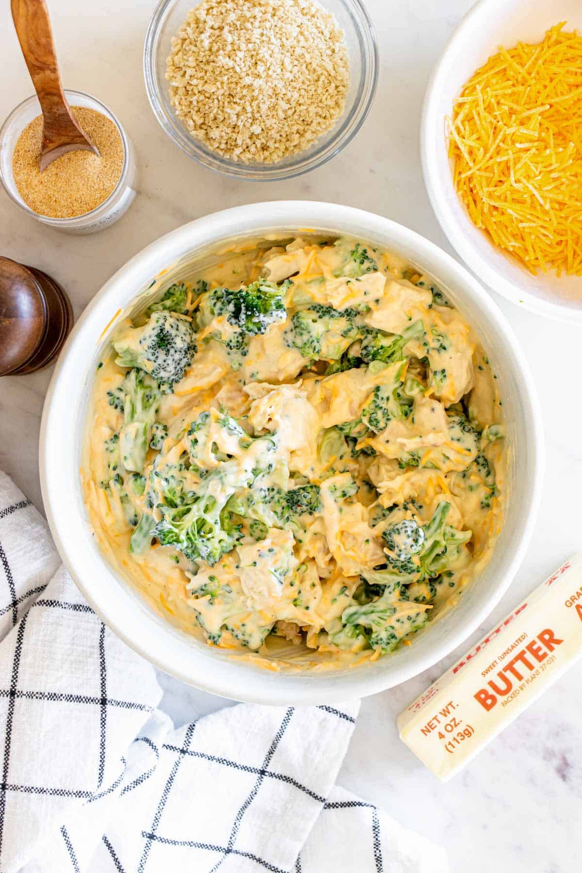 A bowl of broccoli dip with cheese and other ingredients.
