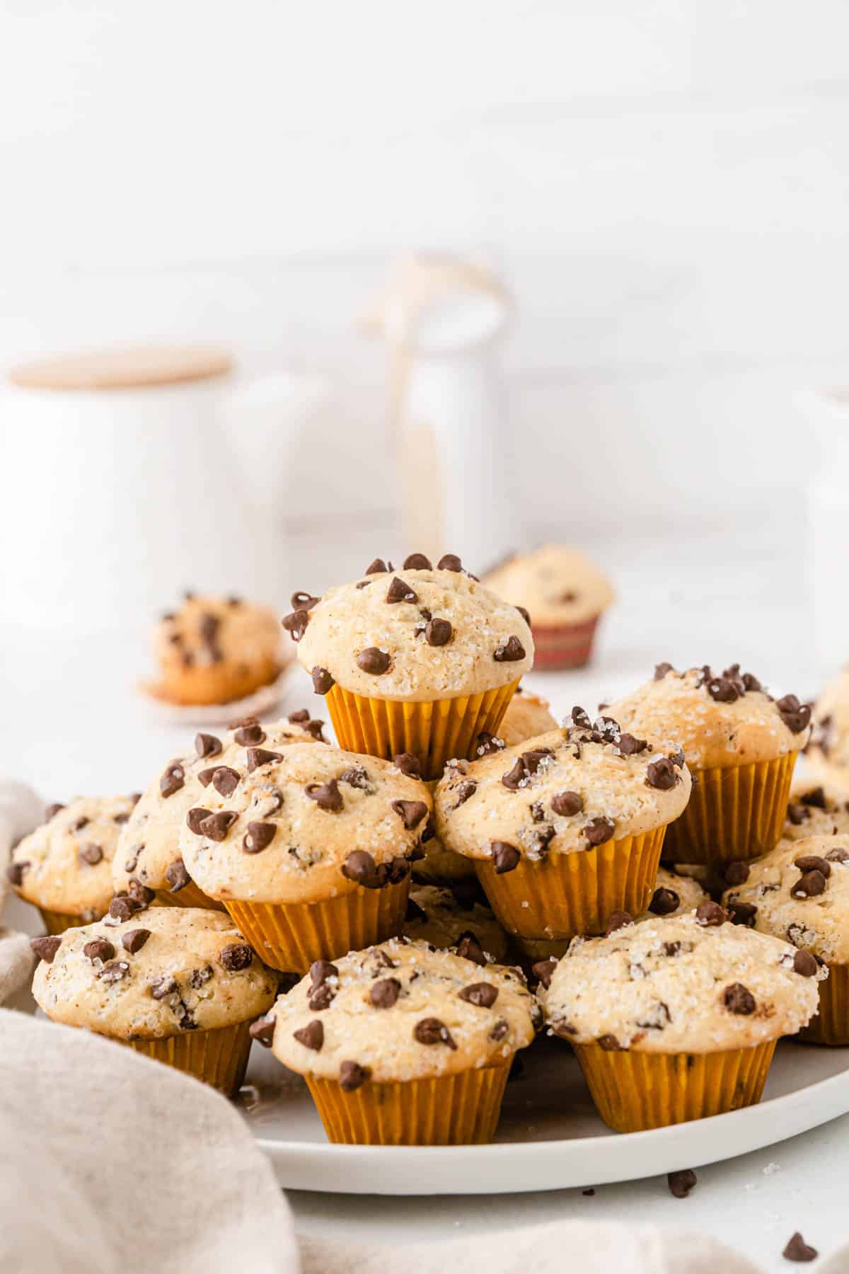 A stack of chocolate chip muffins on a plate.