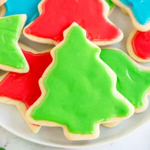 A plate of Christmas Sugar Cookies decorated with green and red icing.