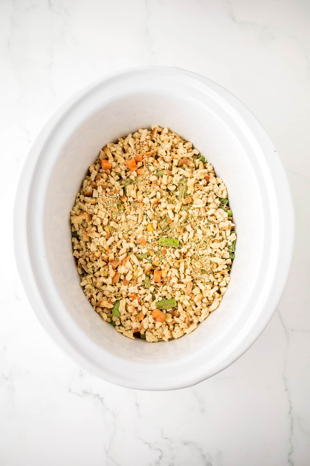 Adding dry stuffing mix containing bread cubes, herbs, and small vegetable pieces is one way of preparing Chicken and Stuffing Casserole