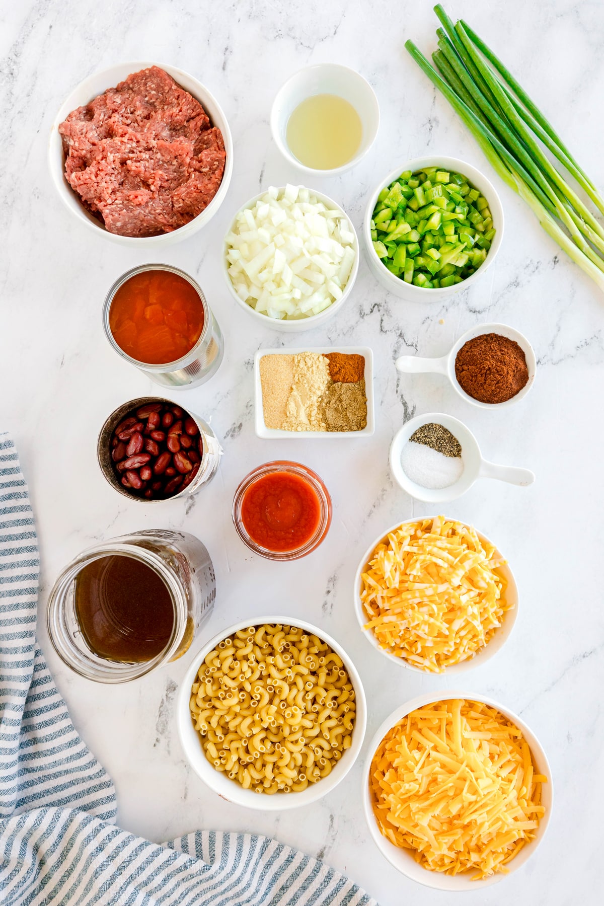 Ingredients for Chili Mac and Cheese is made with vegetable oil, ground beef, onion, green bell pepper, garlic powder, chili powder, mustard powder, cumin, smoked paprika, salt, black pepper, diced tomatoes, tomato sauce, kidney beans, beef broth, elbow macaroni, cheddar cheese, Colby Jack cheese, and green onion.
