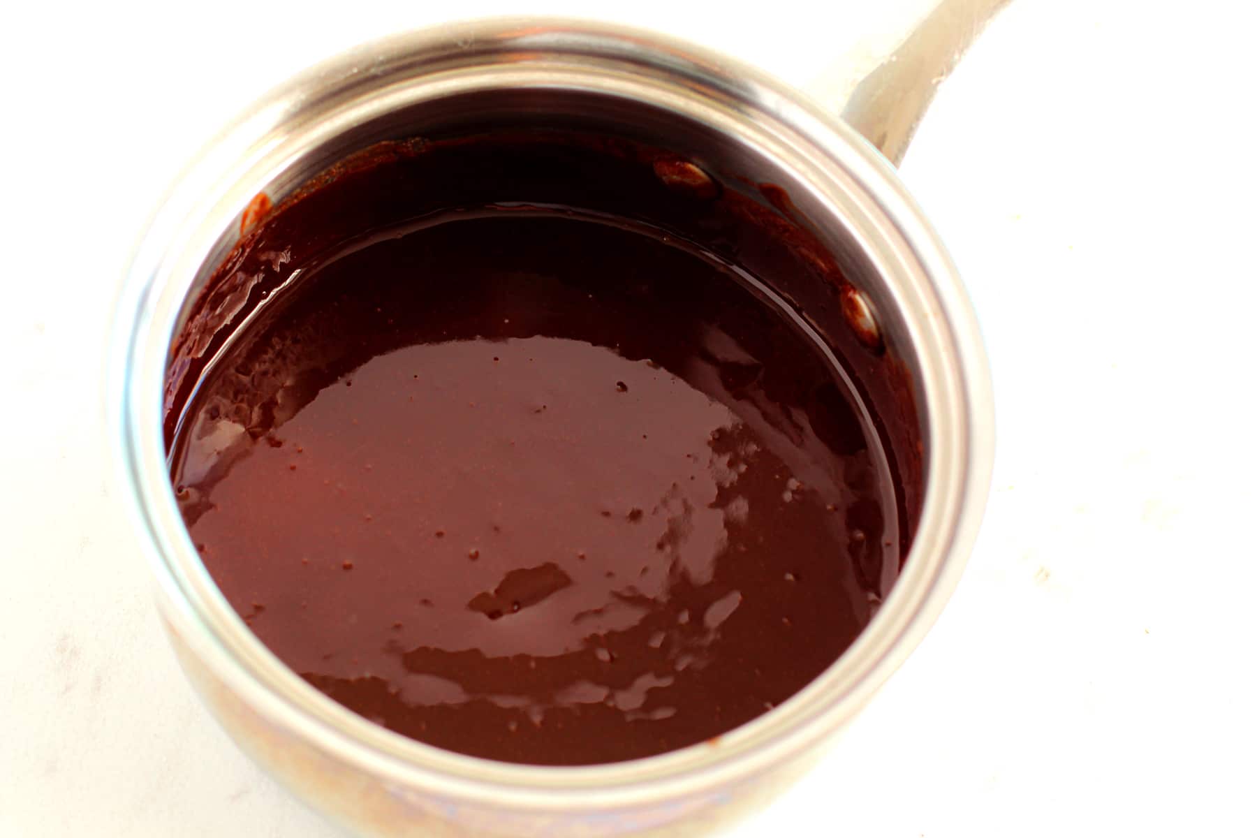 Melting butter in a saucepan is one process in preparing Fudgy Brownies