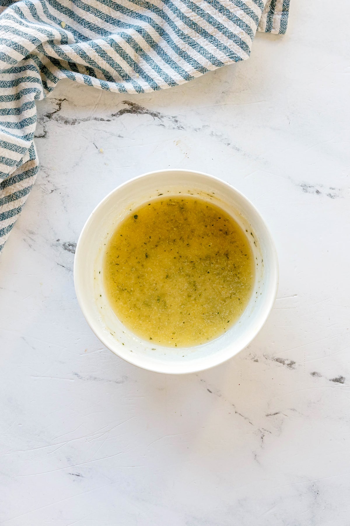 A white bowl containing 4 tablespoons of butter and ranch seasoning for Crockpot Ranch Pork Loin recipe.