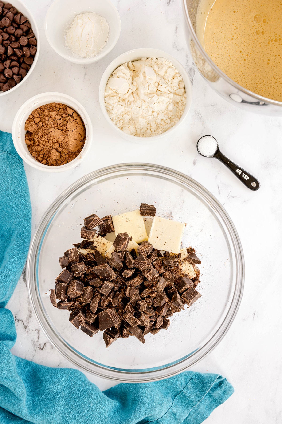 Next step in preparing Easy Brownie Recipe is to mix chopped chocolates with butter in a bowl.