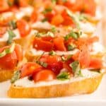 whipped feta with chopped tomatoes on a crostini