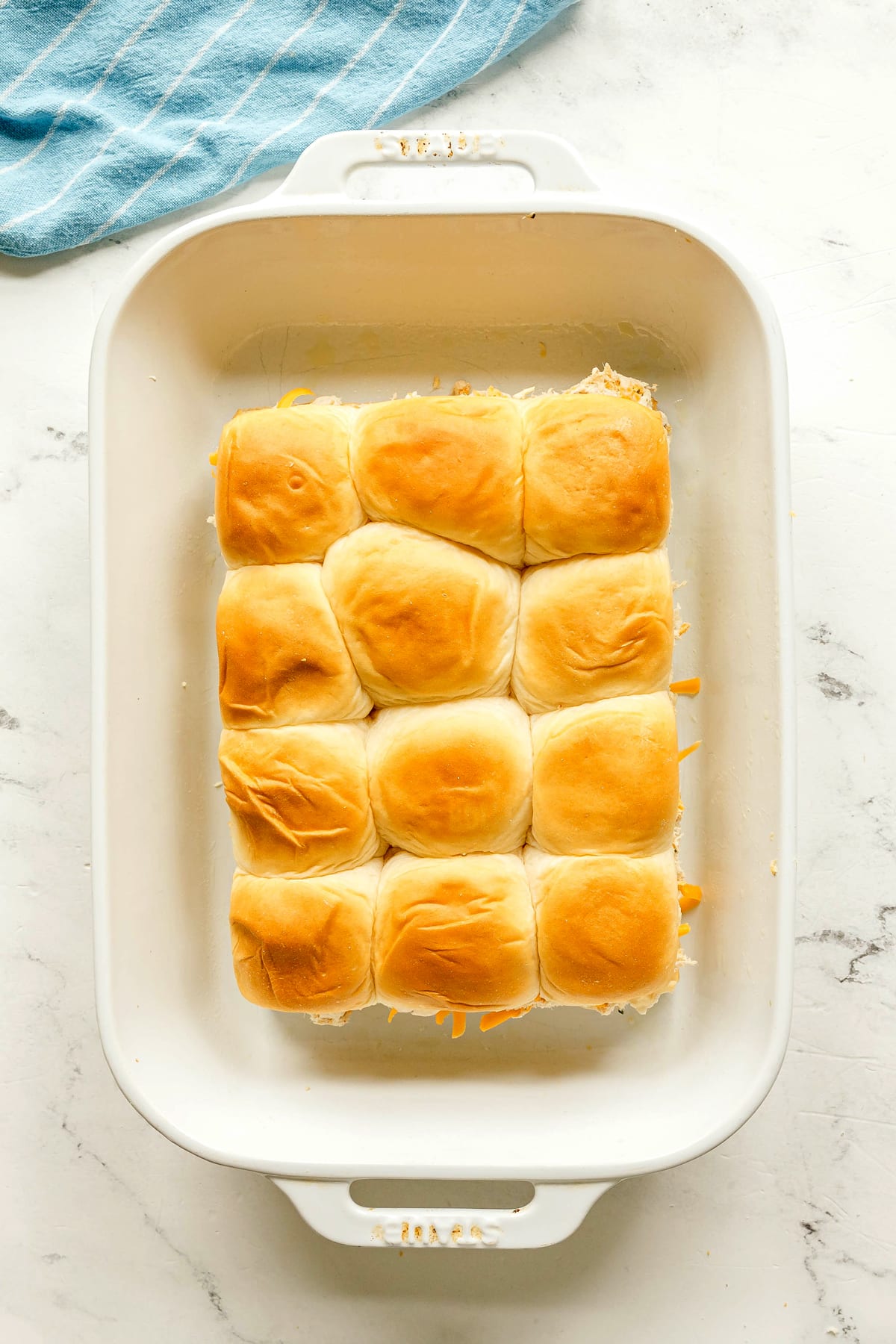 Next step in preparing Crack Chicken Sliders is to cover the other half of roll with the top part of it.