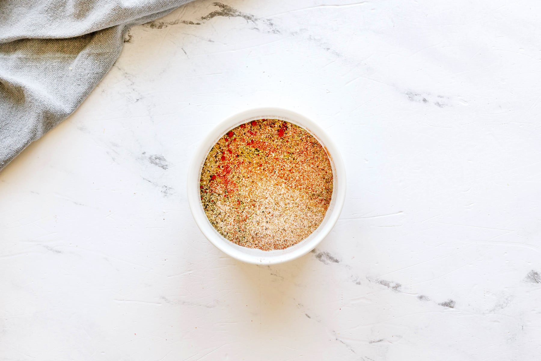 Next step in preparing Air Fryer Chicken Thighs is to mix paprika, garlic powder, onion powder, salt, pepper, and Italian seasoning in a small bowl.