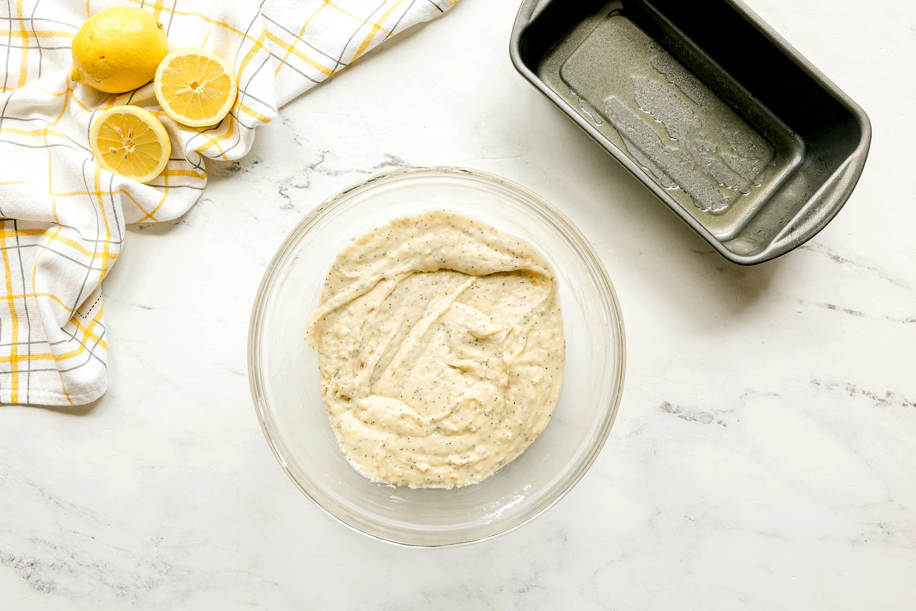 Next step in preparing Lemon Poppy Seed Bread is to whisk together the egg, milk, oil, vanilla, lemon zest, lemon juice, and poppy seeds until well combined.