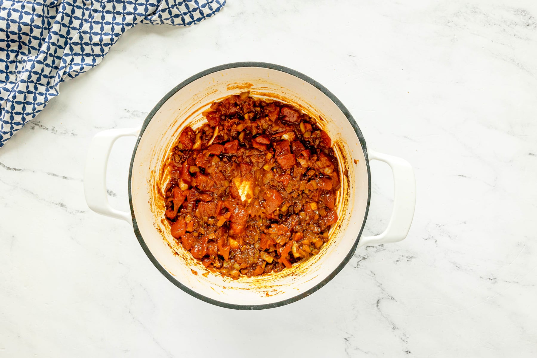Next step in preapring Chicken Masala Recipe is to add tomatoes in the mixture and wait for it to soften.