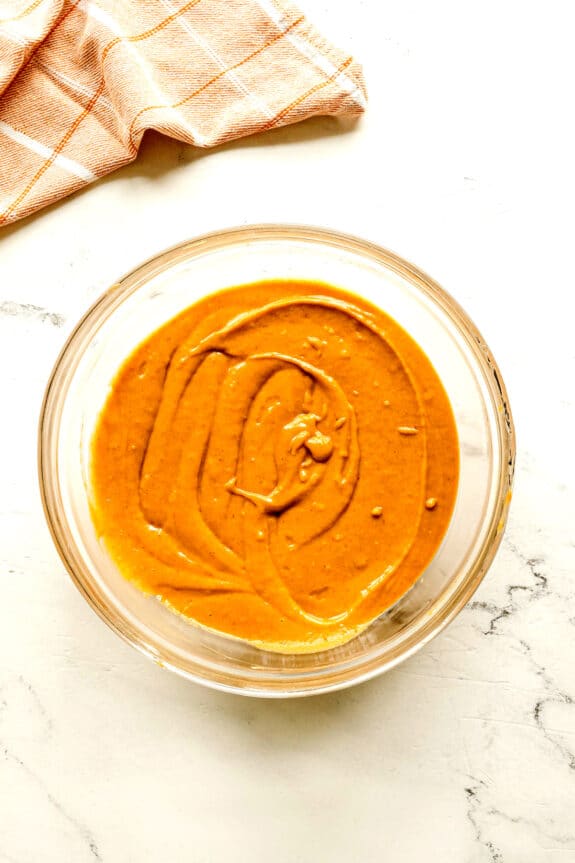 A mixture of wet and dry ingredients for Starbucks Pumpkin Bread recipe.