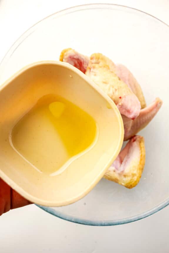 Adding a small bowl of avocado oil for Air Fryer Frozen Chicken Wings recipe.