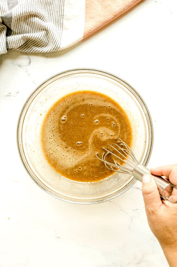 Next step in preparing Sweet Potato Pie is to use a medium bowl, then whisk together the granulated sugar, brown sugar, cinnamon, cloves, ginger, nutmeg, allspice, salt, vanilla, eggs, egg yolk, and evaporated milk until well combined.